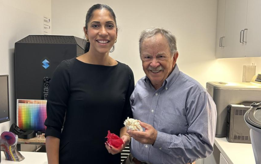 Two people in lab holding heart models