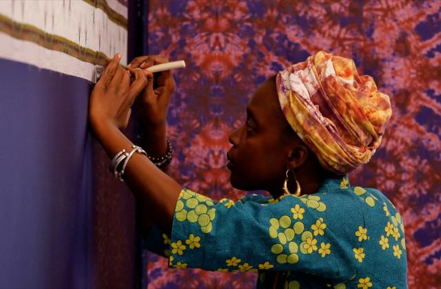 Artist Adama Delphine Fawundu with her new installation in the Miller Theatre lobby