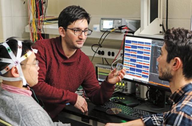 Dion Khodagholy (center) with researchers in his lab